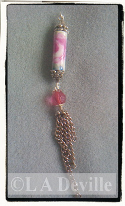 Paper bead pendant with chains.