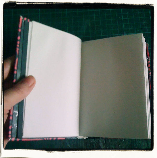 Open notebook showing plain paper pages.